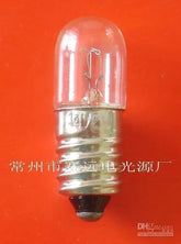 24v 2w e10 miniature 10x28 lamp light bulb a232 with clear glass and metal base on orange background